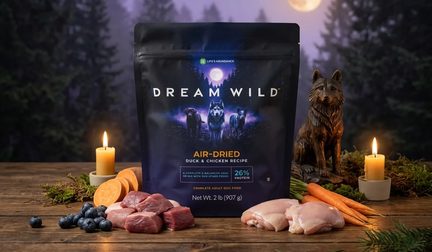 Dream Wild Air-Dried bag on a candlelit table with duck, carrots and blueberries under a purple night sky