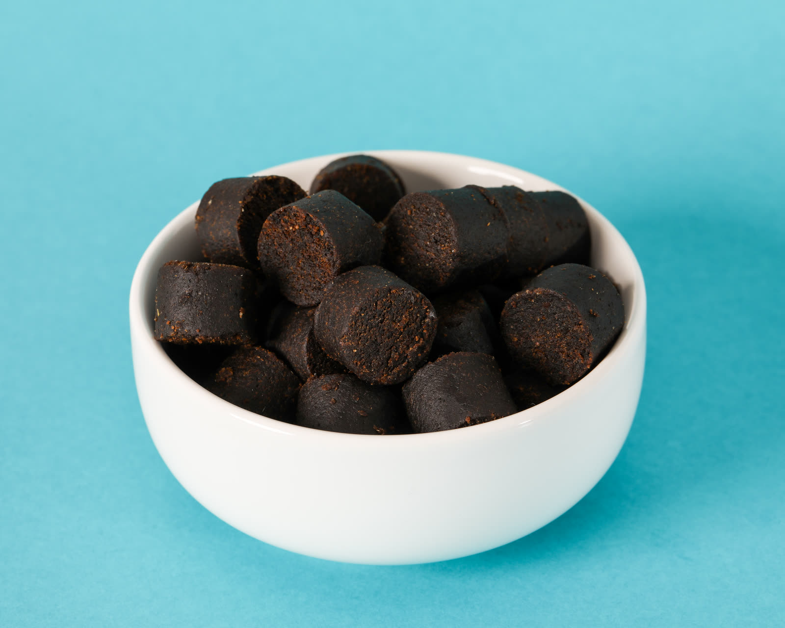 Agility Soft Chews in a white bowl on a teal background