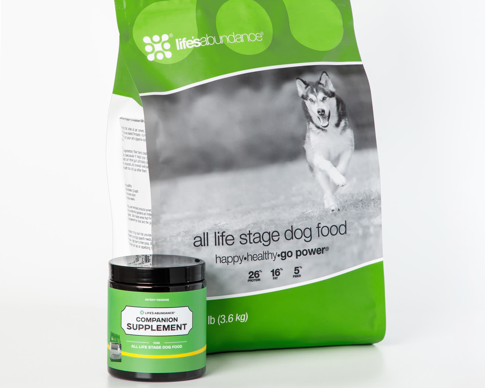 Daily Nutrition System for dogs: bag of All Life Stage food with its Companion Supplement chews jar on a white studio background