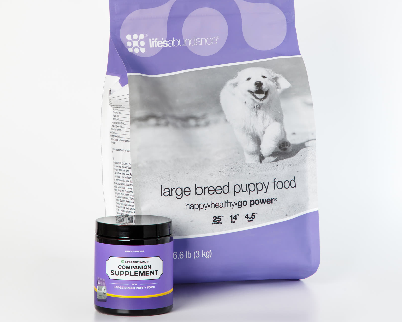 Daily Nutrition System: bag of large breed puppy food with its Companion Supplement chews jar on a white studio background