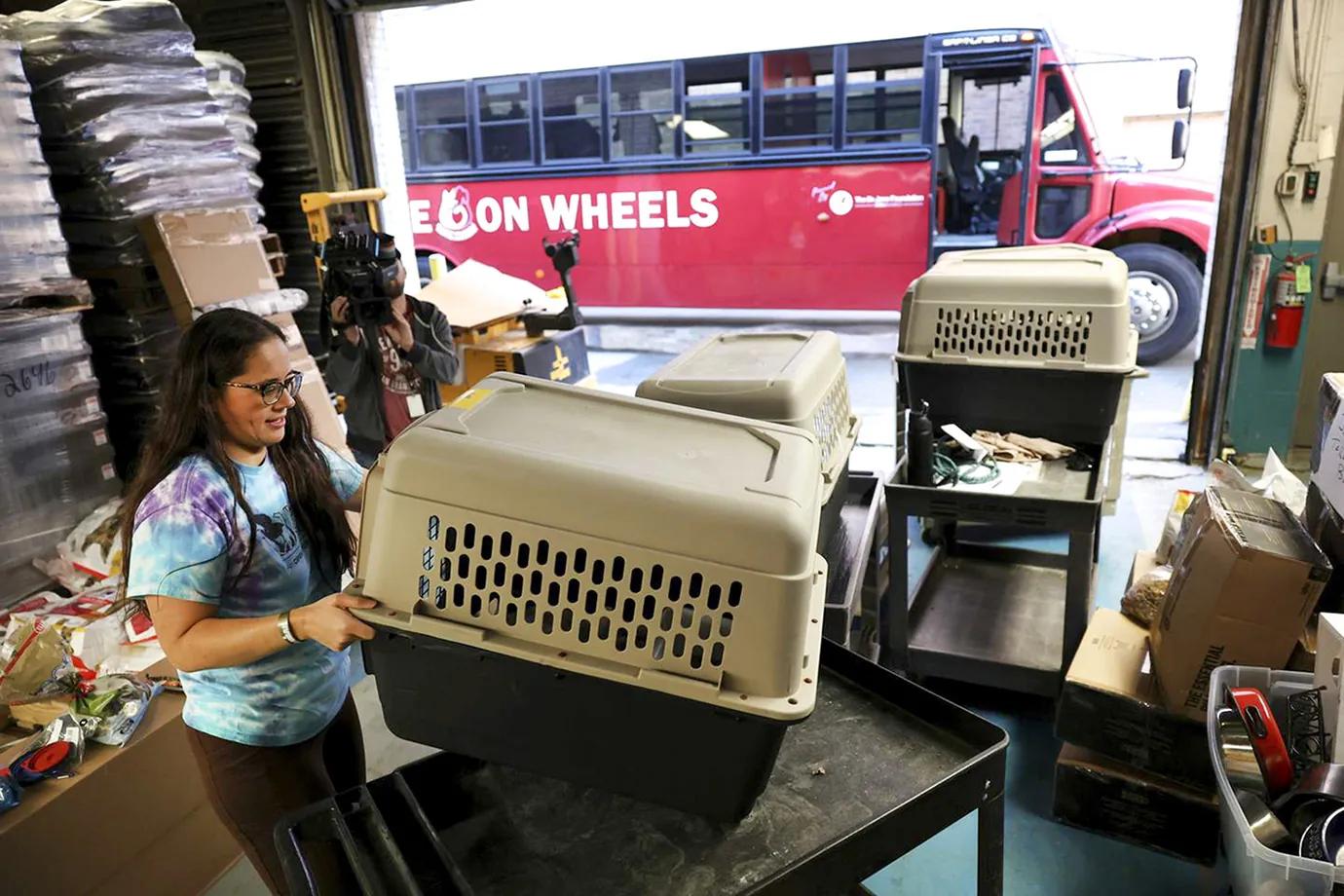 A volunteer loading pet carriers onto the Hope on Wheels rescue bus